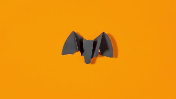 Black Paper Bat Flies Orange Background Concept Greeting Card Halloween — Vídeo de stock