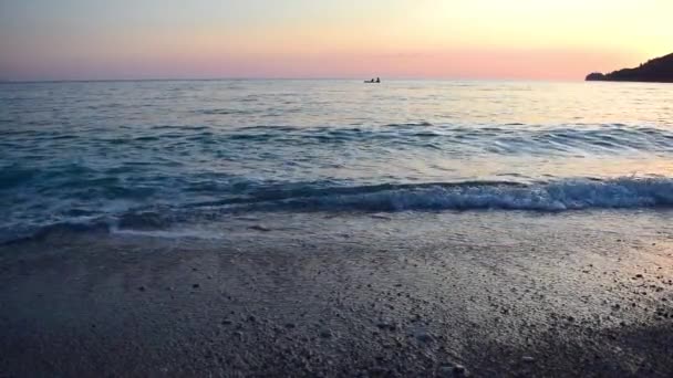 Calm Sea Surf Foreground Small Boat Two Fishermen Pink Sunset — Stockvideo