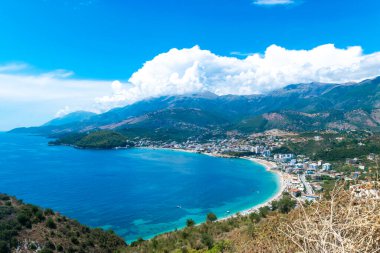 Panoramic view from the top on the resort Himare town. Beautiful summer cloud mountain landscape. Ionian sea. Albania.