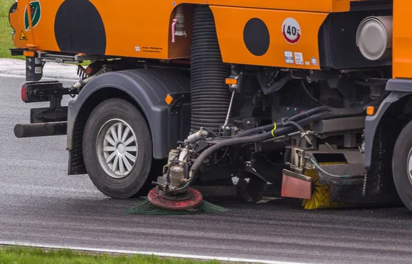 Close-up sweeper machine cleaning streets. Concept clean from debris. Collecting a garbage