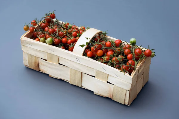 fresh tomatoes in a box on a white background