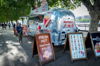 London,England,UK-July 21 2019: Makeshift eateries,specializing in tasty meals from around the world,offer tasty snacks and munchies to passing tourists on a warm summer afternoon in central London.