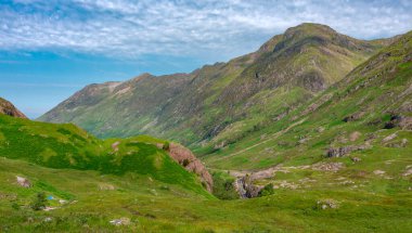 Beautiful,area of the Highlands,covered in green summer grass,blue sky above.The A82 road winding between the magnificent scenery,popular with tourists,hikers,climbers and stock photographers!