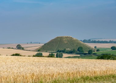 Famous ancient landmark in the countryside of southwest England,a prehistoric,man made chalk mound,the tallest in Europe. clipart