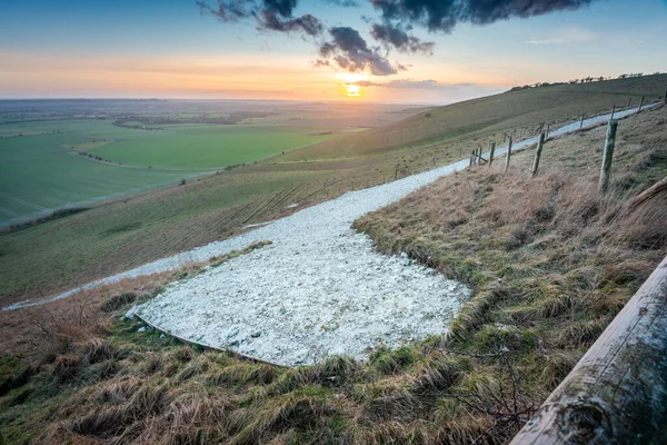 Wide view of the Horse tail,the rest of the iconic chalk hill figure,first cut in 1812, leading off along the hillside,at sunset in the English winter on a clear day,a historic British landmark.
