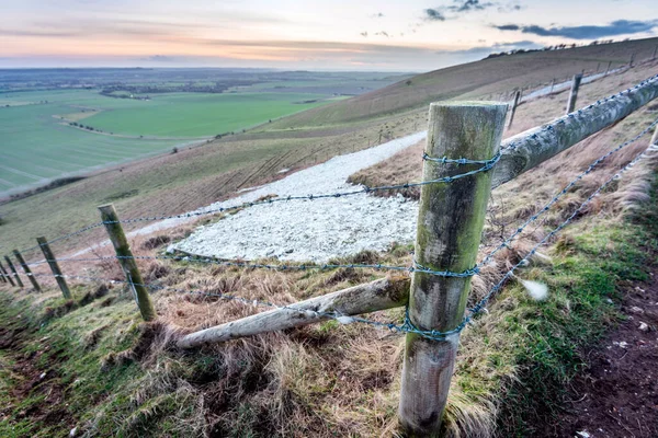 Wide view of the Horse tail,the rest of the iconic chalk hill figure,first cut in 1812, leading off along the hillside,at sunset in the English winter on a clear day,a historic British landmark.