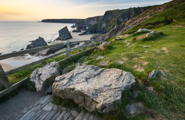 Bedruthan Steps tourist and beauty spot,a stretch of National Trust coastline on the north Cornish coast near Padstow and Newquay,in mid summer,with calm,fair weather Atlantic Ocean waters beyond.