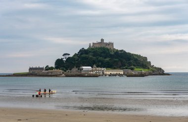 Saint Michael 's Mount, Cornwall, İngiltere, İngiltere, 24 Temmuz 2021: Mount' s Bay Pilot Klübünün bayan üyeleri sabah antrenmanı sırasında Saint Michael 's Mount' ta kürek çekmeye hazırlanıyorlar.