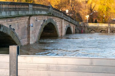 Bewdley, Worcestershire, İngiltere, UK- 22 Şubat 2022: Bewdley Köprüsü ve ötesinde, Severn Nehri 'nin her iki yakasına yerleşim bölgeleri yakınlarındaki Severn Nehri' nin her iki yakasına da uzun metal savunma kalkanları kuruldu...