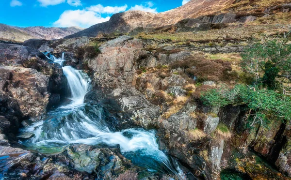 Clear fresh mountain spring water,flowing down from the Welsh,Snowdonian mountains in North Wales,on a clear sunny day in mid March.