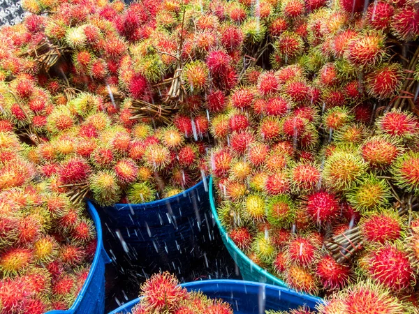 Rambutan fruit in Thailand is in the back of a truck to buy fruit from farmers. Water on the surface of the fruit as they have to travel long distances to bring fresh fruit to the market.