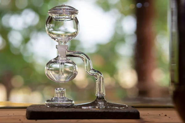 Siphon coffee maker made of glass, beautiful shape design in a coffee shop