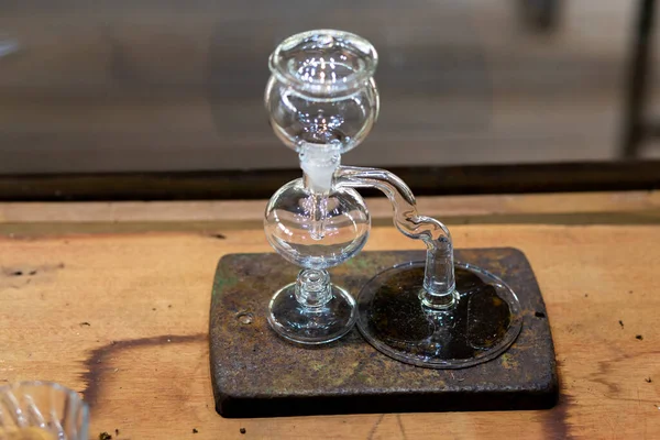 Siphon coffee maker made of glass, beautiful shape design in a coffee shop