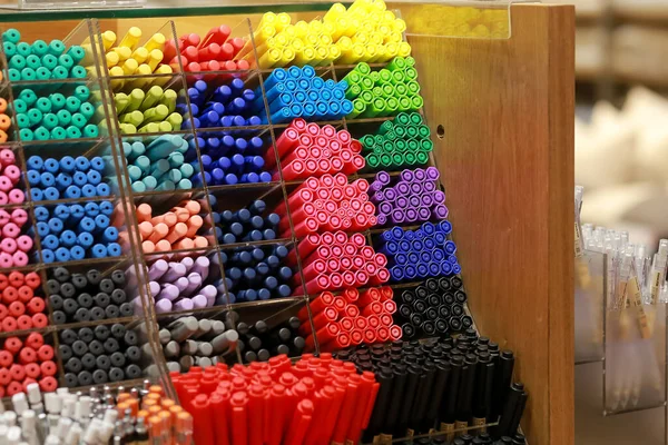 Colorful pens on display boxes in a stationery stor