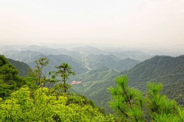 The mountains of Tian Mu located in Zhejiang Province China as seen from the Tree King Scenic Area. clipart