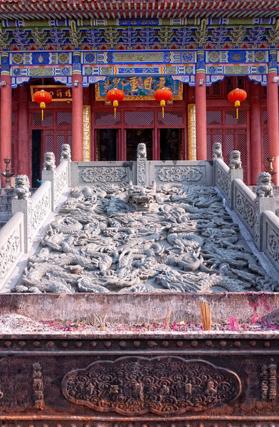 An incense burner and stone dragon carving in front of Tian Mu Chong Guang hall at Chan Yuan Temple in Tianmu shan area in Zhejiang province China.