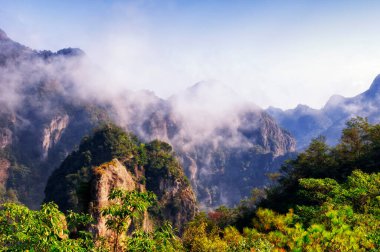 A low hanging cloud against blue sky in the early morning at Fangdong Scenic Area on Yandangshan mountains located in Zhejiang province China.