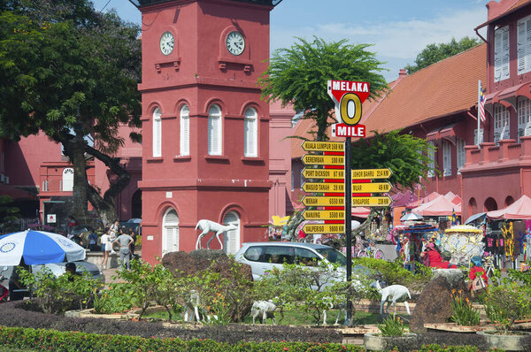 Melaka, Malaysia. August 17, 2017. the historic clock tower near christ church and milage marker in the city of Melaka Malaysia world unesco heritage site.