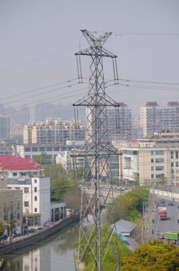 Urban cityscape and high tension power lines in Shanghai China. clipart