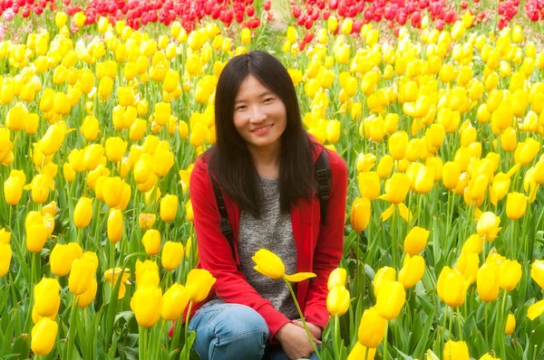 Chinese Woman Smiling Sitting Field Yellow Red Tulips Shanghai China — Stockfoto