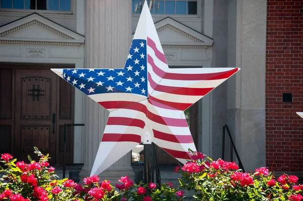 An American flag star in front of a building in West Hartford blue back square area of Connecticut.