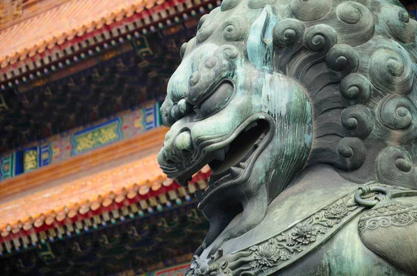 A metal chinese lion statue within the forbidden city in front of the Gate of Supreme harmony (tianhe men) in Beijing China.