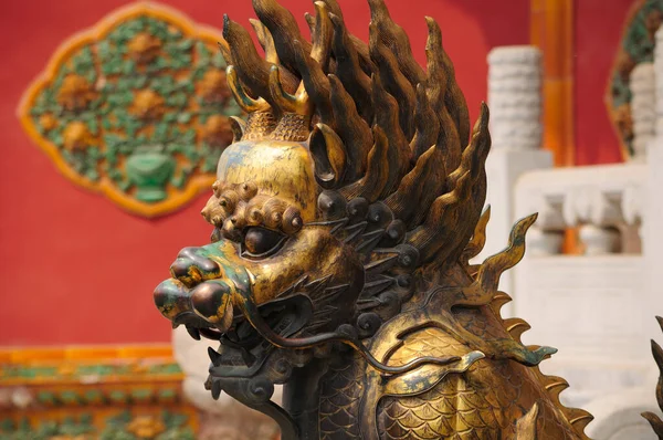 A bronze weathered and worn Chimera statue within the forbidden city in Beijing China.