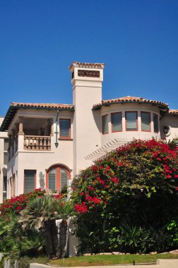 The generic architecture of West Coast Beach homes on Manhattan beach California on a sunny blue sky day.