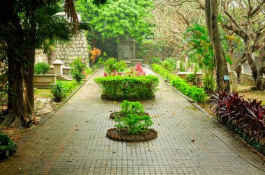 Gravestones at the protestant cemetery at morrison chapel on the island of Macau China on a rainy day.  