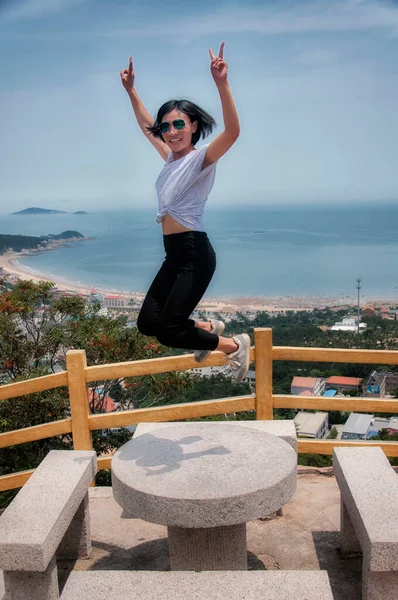 Chinese Woman Jumping Table Overlook Area Mount Lao Qingdao China — Stockfoto