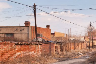 A run down residential area in the rural city of zhaodong china in heilongjiang province on a later afternoon day.
