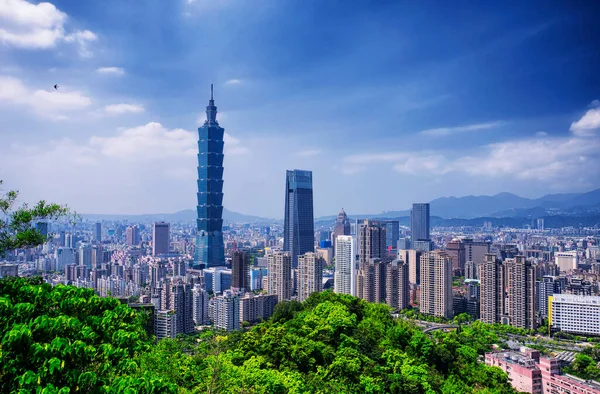 The Taipei 101 landmark building rising above generic architecture in the city of Taipei Taiwan on a sunny day as seen from Xiangshan or Elephant Mountain.
