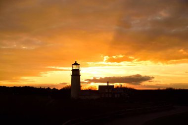 A silhouette of the Highland or Cape Cod Lighthouse at sunset in Cape Cod Massachusetts.