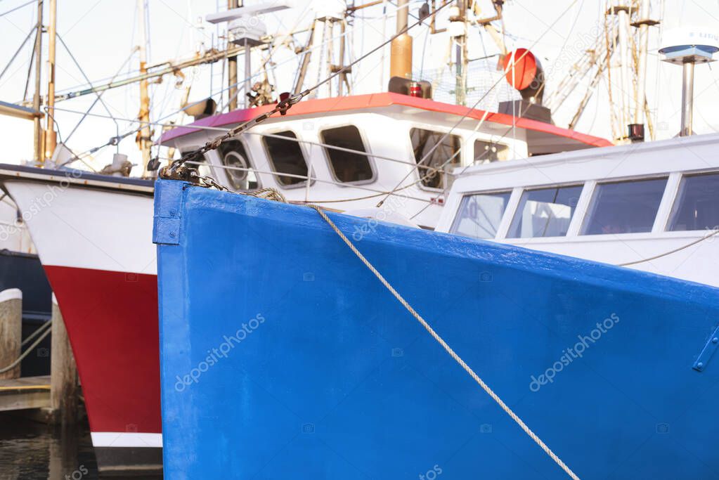 Blue and red fishing boats docked in the inner harbor on Lewis Bay in Hyannis Massachusetts  new england.