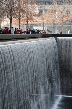 March 19, 2016. New York City, New York. Tourists around Ground Zero 9/11 memorial in Manhattan in New York City on a cold spring day.  