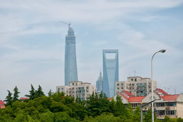 The Shanghai Tower, Jin Mao Tower and the Financial Center towering over the Lujiazui skyline in Pudong, Shanghai China.