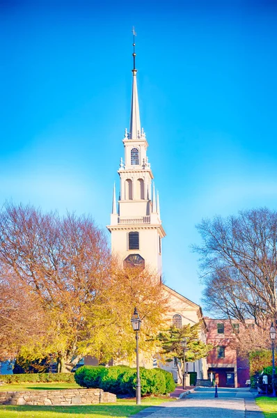 The landmark trinity church in Queen Anne Square in late autumn in Newport Rhode Island. 