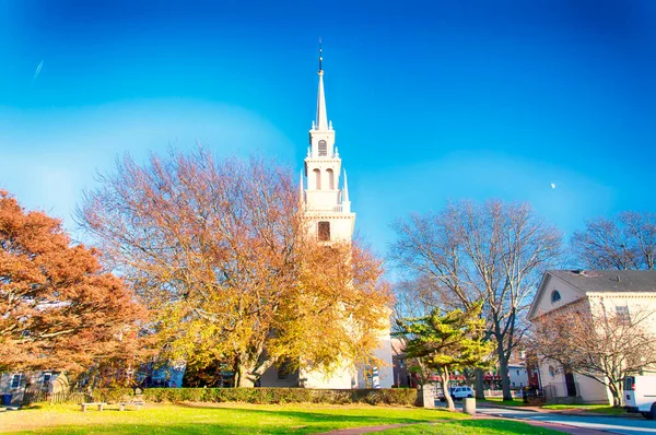 The landmark trinity church in Queen Anne Square in late autumn in Newport Rhode Island.
