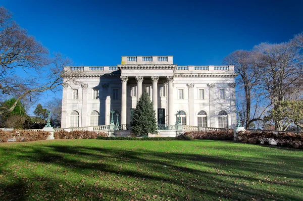 the front entrance of the historic marble house in Newport Rhode island on a late autumn sunny day.