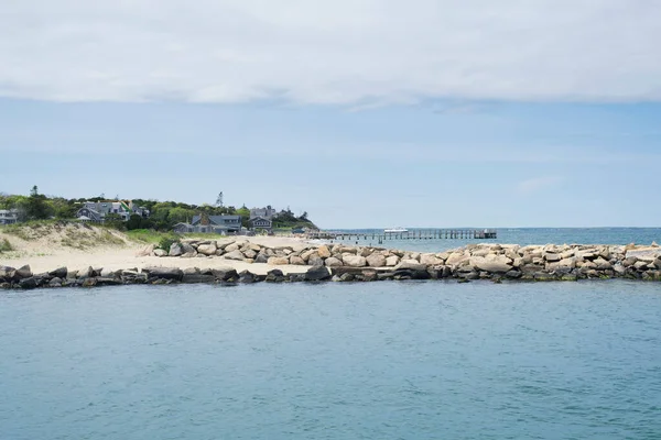 A rock jetty out into the atlantic ocean at oak bluffs massachusetts, on a cloudy day on martha's vineyard. 