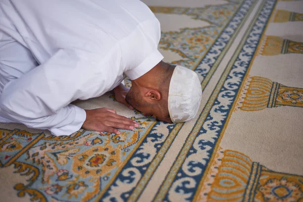Sebuah pandangan tertutup dari seorang pria Muslim berlutut dalam doa — Stok Foto