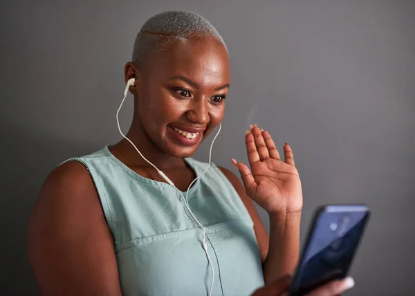 A young Black businesswoman waves on a video call with grey background — Φωτογραφία Αρχείου