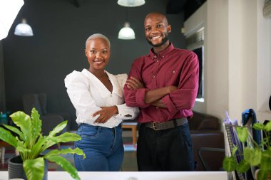 Two Black co-founders pose with arms crossed with their business. High quality photo