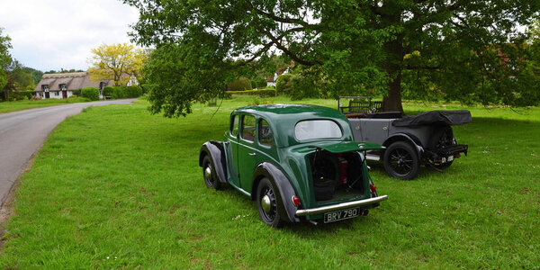 ICKWELL, BEDFORDSHIRE, ENGLAND - JUNE 06, 2021:  Vintage Morris 8 and Austin Motor Cars parked on Ickwell Village Green.