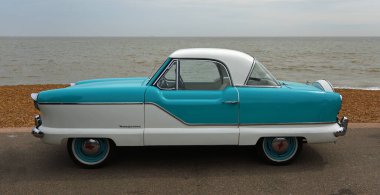 FELIXSTOWE, SUFFOLK, ENGLAND - MAY 01, 2022: Classic Blue and White Nash  Metropolitan Motor  Car Parked on Seafront Promenade.   