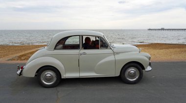 FELIXSTOWE, SUFFOLK, ENGLAND - MAYIS 01, 2022: Deniz kenarında park edilmiş klasik White Morris Minor motorlu araba.