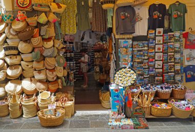 SOLLER, MALLORCA, SPAIN - JUNE 21, 2022: Shop Display Wicker Baskets and bags T-Shirts and books.