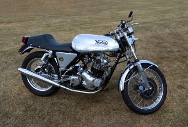 LITTLE GRANSDEN, CAMBRIDGESHIRE, ENGLAND - AUGUST 28, 2022: Classic Norton motorcycle parked on grass.