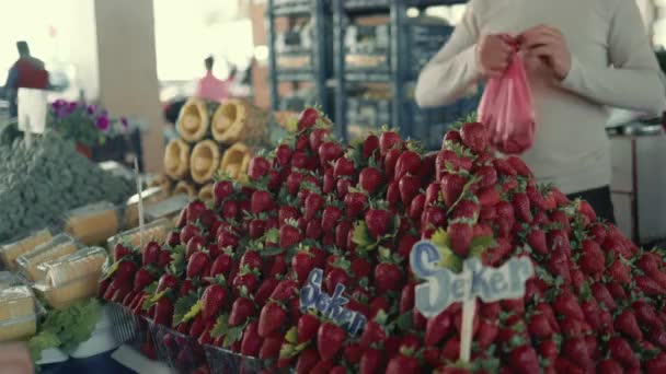 Seller put strawberries in plastic bag and gave it to buyer in the farm market. Slow motion — 비디오