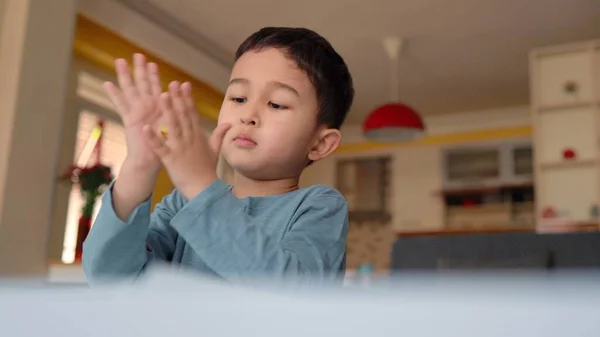 Cute asian preschooler engaged in creativity. Close-up view of hands rolling clay. — Stockfoto